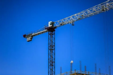 Construction concept. A new building under construction against the sky. Blue Stock Photos