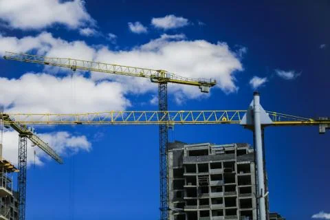 Construction concept. A new building under construction against the sky. Blue Stock Photos