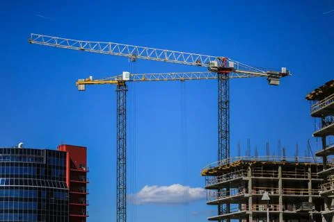 Construction concept. A new building under construction against the sky. Blue Stock Photos