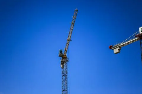 Construction concept. A new building under construction against the sky. Blue Stock Photos