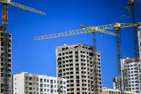 Construction concept. A new building under construction against the sky. Blue Stock Photos