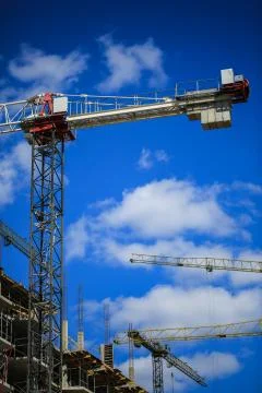 Construction concept. A new building under construction against the sky. Blue Stock Photos