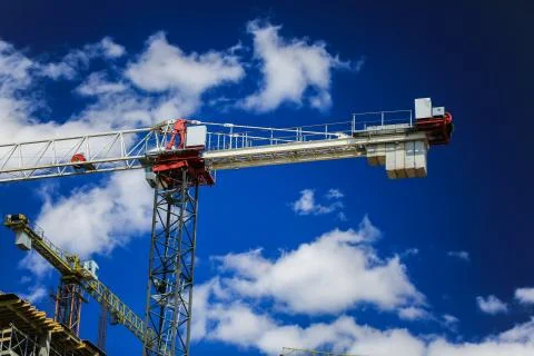Construction concept. A new building under construction against the sky. Blue Stock Photos