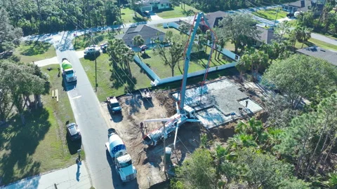 Construction of concrete foundation slab at new house developing site. Workers Video stock 252308624