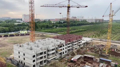 Construction of a concrete multi-storey building. Lifting cranes Stock Footage 276736597