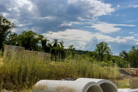 Construction of concrete pipe of drainage system work on the road for drained Stock Photos