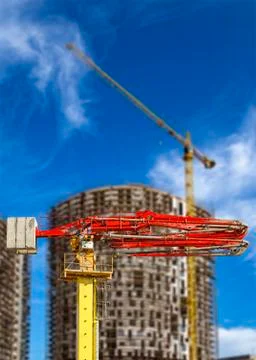 Construction concrete pump with multi-storey building under construction Stock Photos