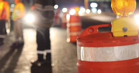 Construction cone deviating the traffic with construction workers on the back 스톡 동영상 156939952