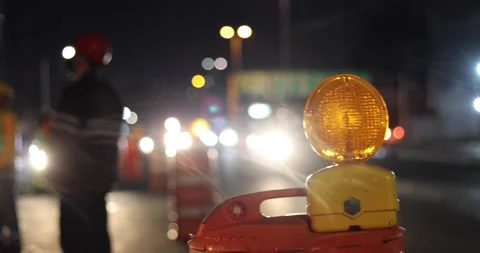 Construction cone deviating the traffic with construction workers on the back 스톡 동영상 156940020