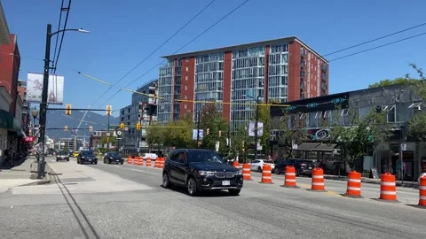 Construction cones on public street while cars driving by Stock Footage 281058590
