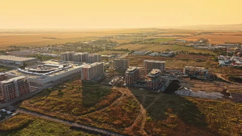 Construction continues on new buildings in a developing area during sunset in Stock Footage 341393018