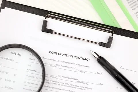 Construction contract form on A4 tablet lies on office table with pen and m.. Stock Photos