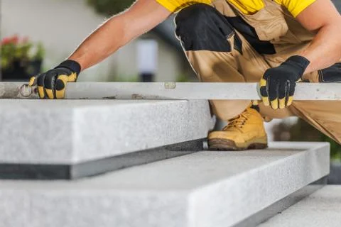 Construction Contractor Checking Stairs Levels Using Large Spirit Level Tool. 写真素材