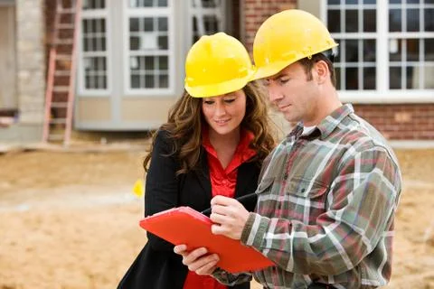 Construction: contractor points out things on checklist Stock Photos