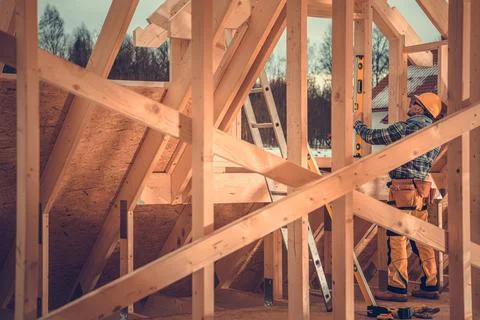 Construction Contractor Supervisor Performing Final Levels Check on Wooden Sk 写真素材