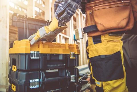 Construction Contractor Worker and His Tools Boxes Stock Photos