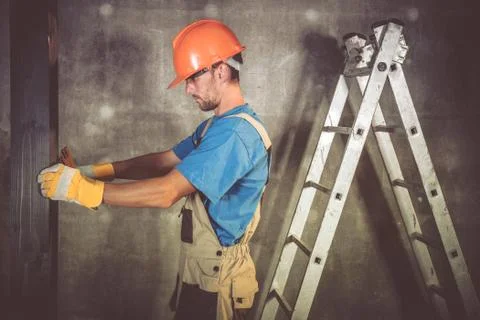 Construction Contractor Worker in His 30s Measuring Wooden Elements Stock Photos