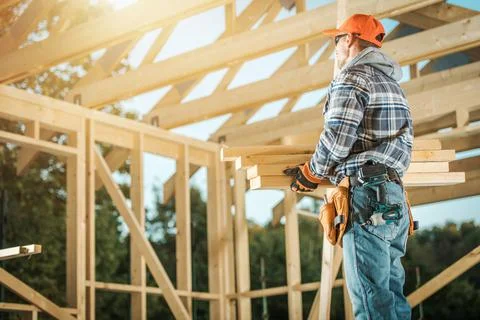 Construction Contractor Worker Moving Pieces of Wood Building Structure Eleme 库存照片