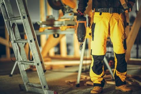 Construction Contractor Worker with a Nail Gun in His Hand Stock Photos