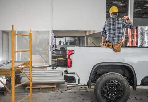 Construction Contractor Worker Taking Short Brake Seating on His Pickup Truck Stock Photos