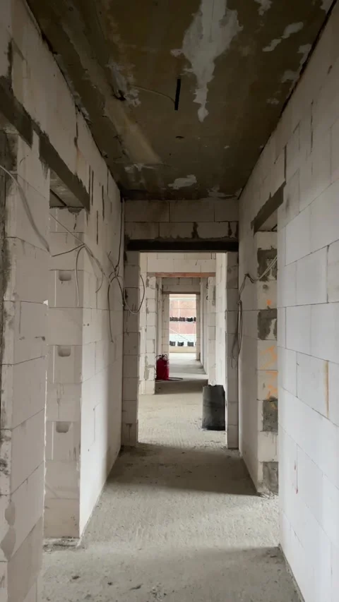 Construction Corridor With Cables And Bags, Unfinished Passage Featuring Wiring Stock Footage 323626945