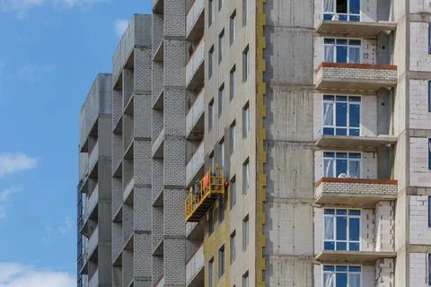 Construction cradle on a multi-apartment residential building under construction Stock Photos