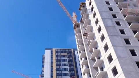 Construction crane against the background of a concrete slab house Stock Footage 309119519