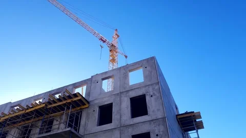 Construction crane against the background slab house under construction. Stock Footage 303649182