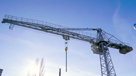 Construction crane against blue sky in the city. 4K Video stock 130670080