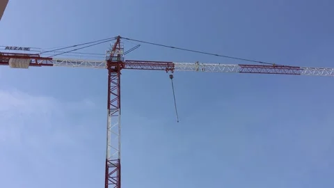 Construction crane against a blue sky Stock Footage 266934091