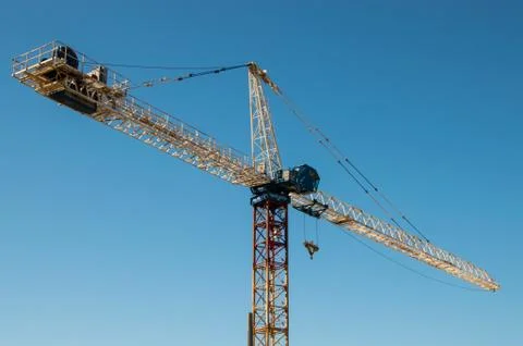 Construction crane against a blue sky Stock Photos