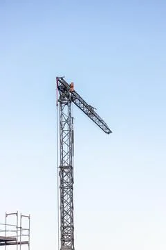 Construction crane against blue sky, free space for insertion. Stock Photos