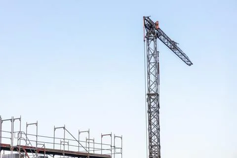 Construction crane against blue sky, free space for insertion. Stock Photos