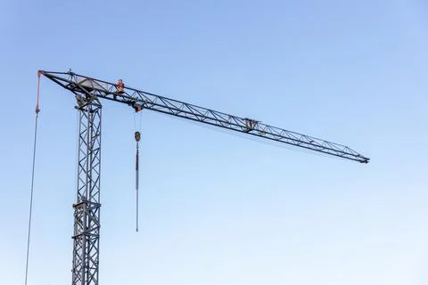 Construction crane against blue sky, free space for insertion. Stock Photos