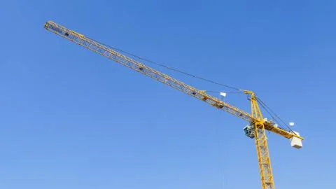 Construction crane against a clear sky. Stock Photos