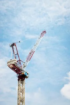 Construction crane against cloudy sky Stock Photos