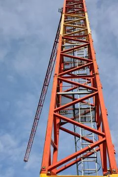 Construction crane against the cloudy sky Stock Photos