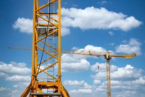 Construction crane against the cloudy sky Stock Photos