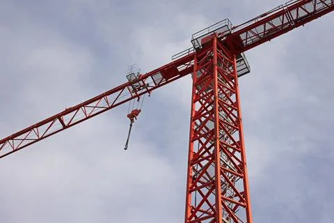 Construction crane against the cloudy sky Stock Photos