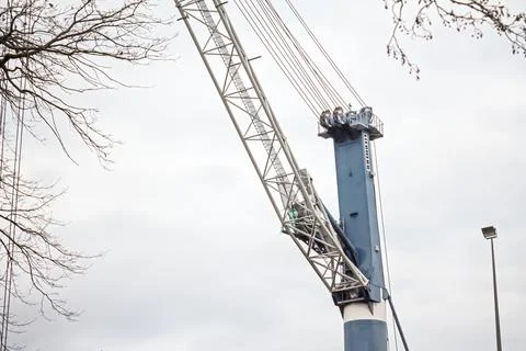 Construction crane against cloudy sky Stock Photos