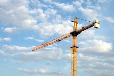 Construction crane against the sky with clouds Stock Photos