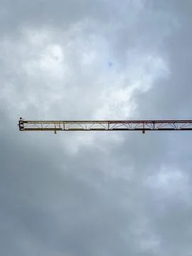 Construction crane againts cloudy evening sky Stock Photos