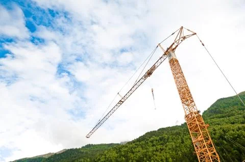 Construction crane in alps Stock Photos