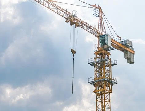 Construction Crane Amidst Active Site with Sky Background Stock Photos