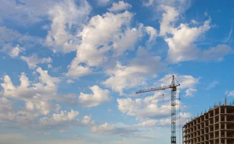 Construction crane and concrete structure against the sky Stock Photos