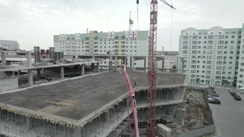 A construction crane and a concrete supply crane during the pouring of floors Stock Footage 219687641