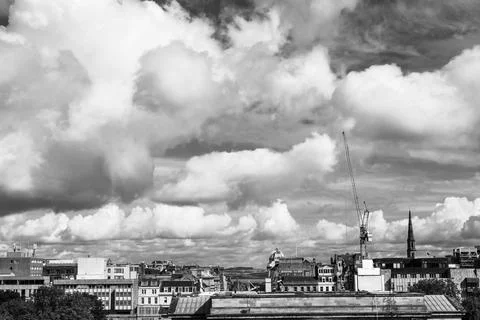 Construction crane and dramatic clouds loom over densely packed Edinburgh, .. Fotos de archivo