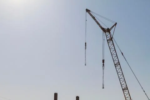 Construction crane on the background of the blue sky Stock Photos