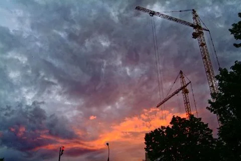 Construction crane on background of evening sky Stock Photos