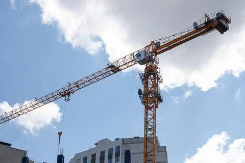 Construction crane on the background of the sky. Construction site. Stock Photos
